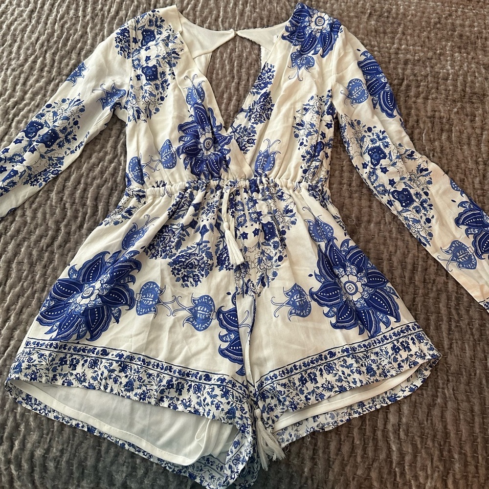 Lovecat romper, low cut front and open back. Size large, barely worn
